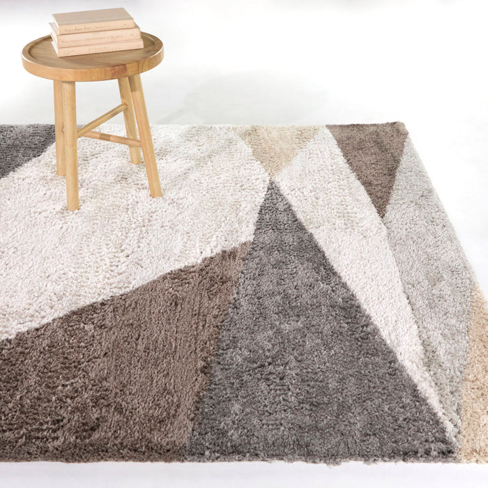 A room setting featuring Brennan Cream 5x8 Geometric Area Rug