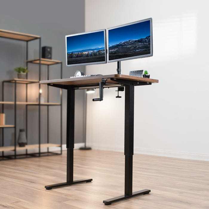 Compact steel desk frame with brown desktop and a dual monitor mount.