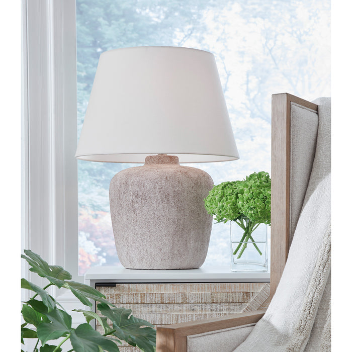 A room setting featuring Danry Distressed Cream Table Lamp