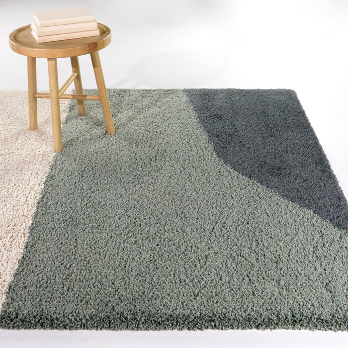 A room setting featuring Engle Green 5x8 Abstract Area Rug