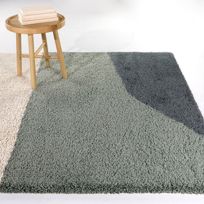 A room setting featuring Engle Green 5x8 Abstract Area Rug