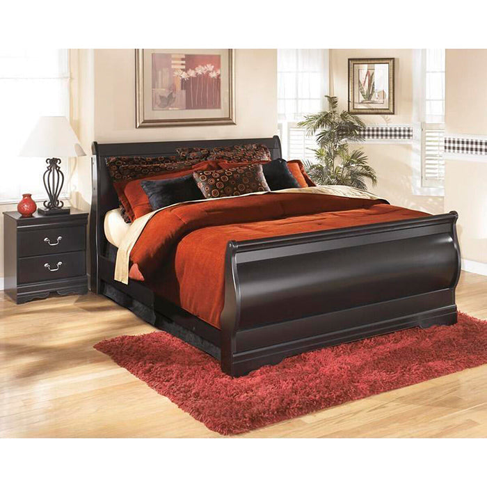 A room setting featuring Huey Vineyard Black Full Sleigh Headboard