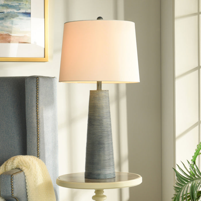 A room setting featuring Michel Washed Denim Table Lamp