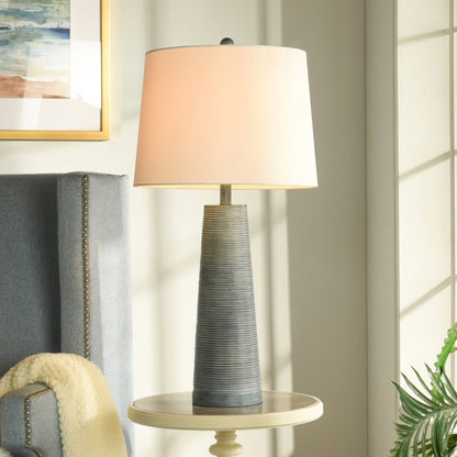 A room setting featuring Michel Washed Denim Table Lamp