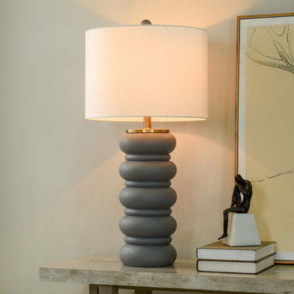 A room setting featuring Remy Charcoal Table Lamp