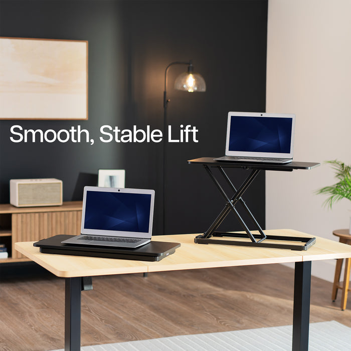 Laptop on a standing desk with 'Smooth, Stable Lift' text in a home office setting.