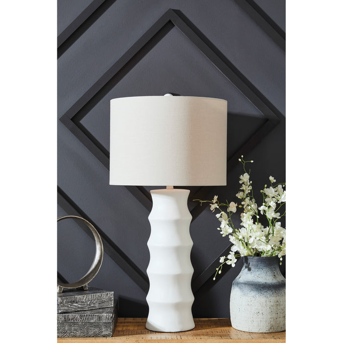 A room setting featuring Veraleigh White Table Lamp